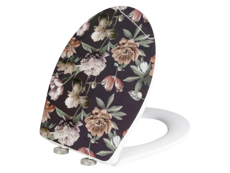 Weißer Toilettensitz mit Blumenmuster.