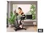 Eine Frau trainiert auf dem Christopeit Sport Ergometer BT 4 in einem modernen Wohnzimmer. [KI-generiertes Bild]