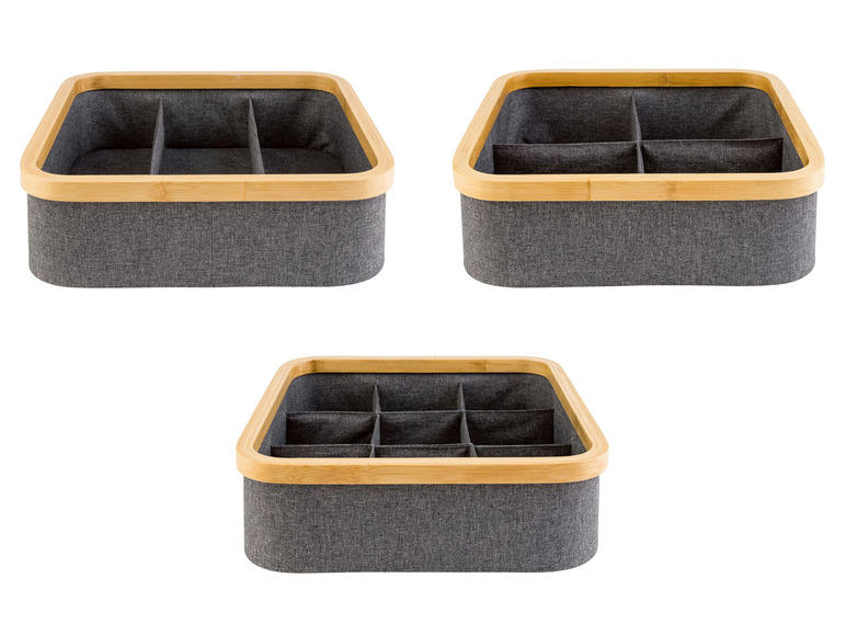 Drei graue Aufbewahrungsboxen mit Holzrand, geeignet für die Organisation verschiedener Gegenstände.