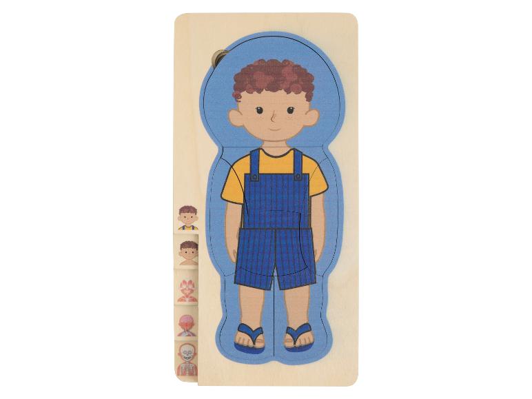 Holzpuzzle mit einem Jungen in blauer Latzhose und Anatomieschichten