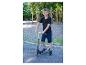 Lächelnder Junge mit Roller auf einem Spielplatz