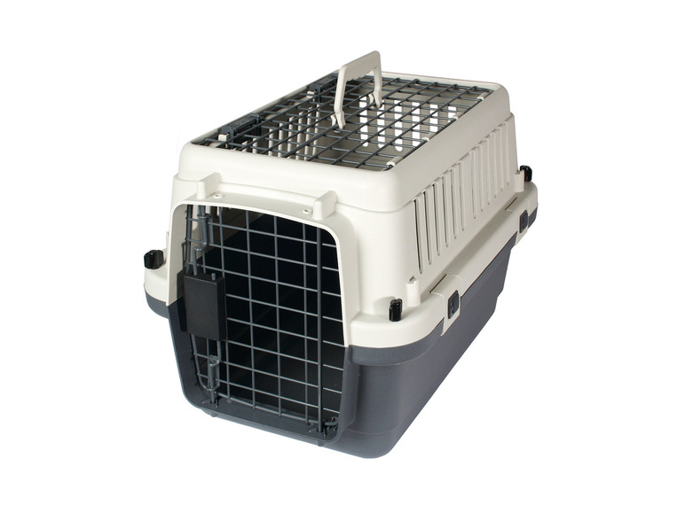 Eine weiße Plastik-Hundetransportbox mit einer Gittertür.
