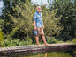 Mann mit einer Gardena Pumpe auf einem Holzsteg am Teich.