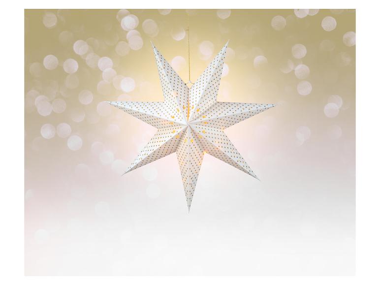 Leuchtender Weihnachtsstern mit goldenem Muster auf Bokeh-Hintergrund.