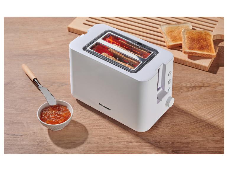 Weißer Silvercrest Toaster mit Toast und Marmelade auf einem Holztisch.