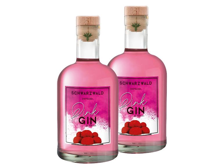 Zwei Flaschen Pink Gin mit Etikett, das rote Beeren und Text zeigt.