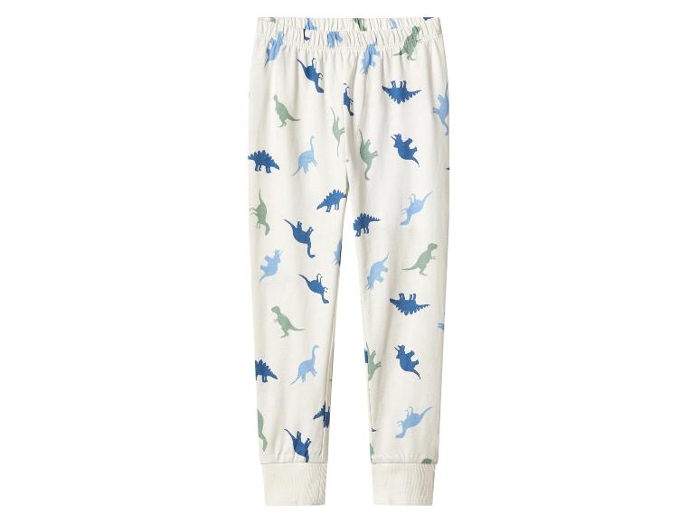Weiße Kinderhose mit Dinosaurier-Print in Blau- und Grüntönen.