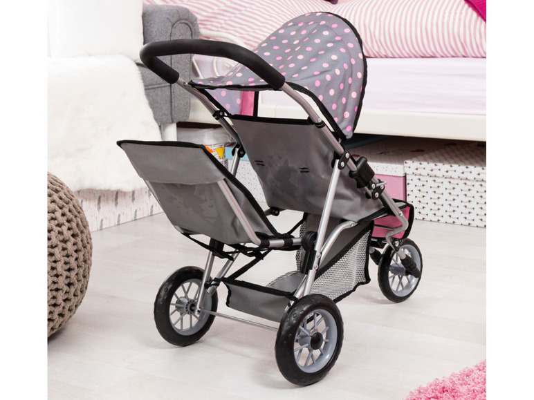 Ein rosa und grauer Kinderwagen mit Punkten