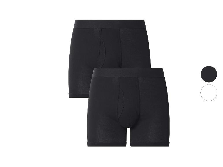 Set aus zwei schwarzen Herren-Boxershorts, mit einem schwarzen und einem weißen Kreis rechts.