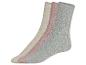 Drei Paar gestrickte Socken in Beige, Rosa und Grau.