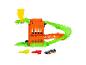 Spielset mit krokodilförmiger Rampe, orangefarbenem Gebäude, grüner Strecke und Spielzeugauto.