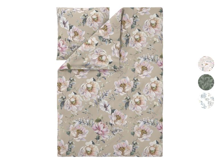 Florales Bettwäsche-Set mit großen hellrosa und weißen Blumen auf beigem Hintergrund.
