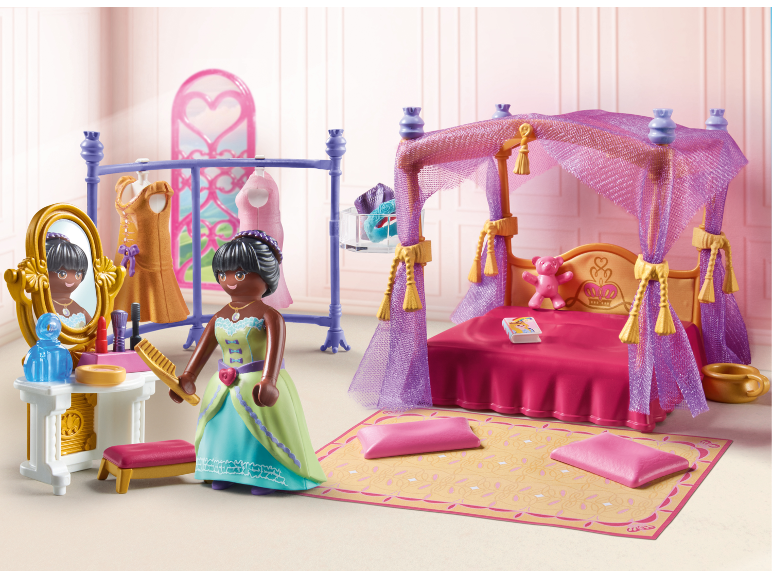 Spielzeug-Prinzessinnen-Schlafzimmer mit Himmelbett, Schminktisch und Spielfigur.