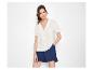 Frau in weißem Kurzarmhemd und blauen Shorts.