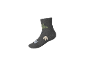 Graue Socke mit grünem Dinosaurier-Motiv und Pfotenabdrücken.