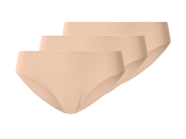 Set aus drei nahtlosen beigefarbenen Damenhöschen, diagonal angeordnet.