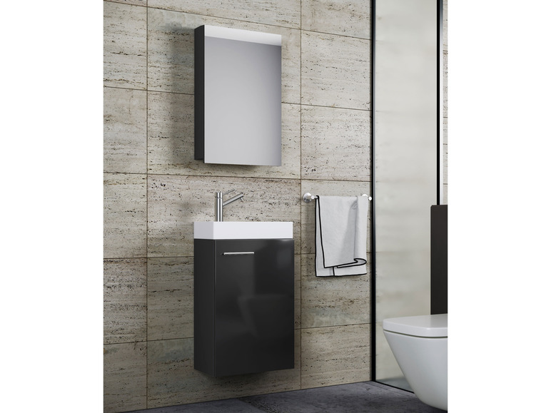 Ein Badezimmer mit Waschbecken, Spiegelschrank und Toilette.