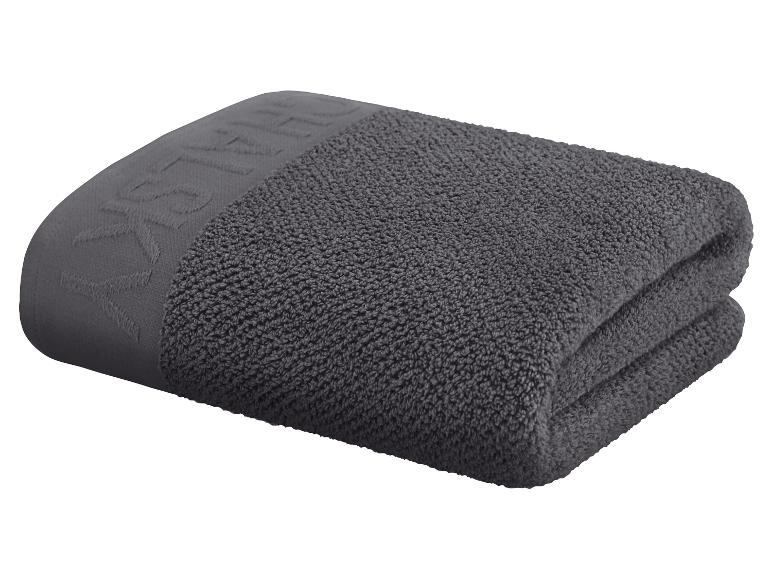 Ein dunkelgraues Handtuch, das auf einem weißen Hintergrund gefaltet ist.