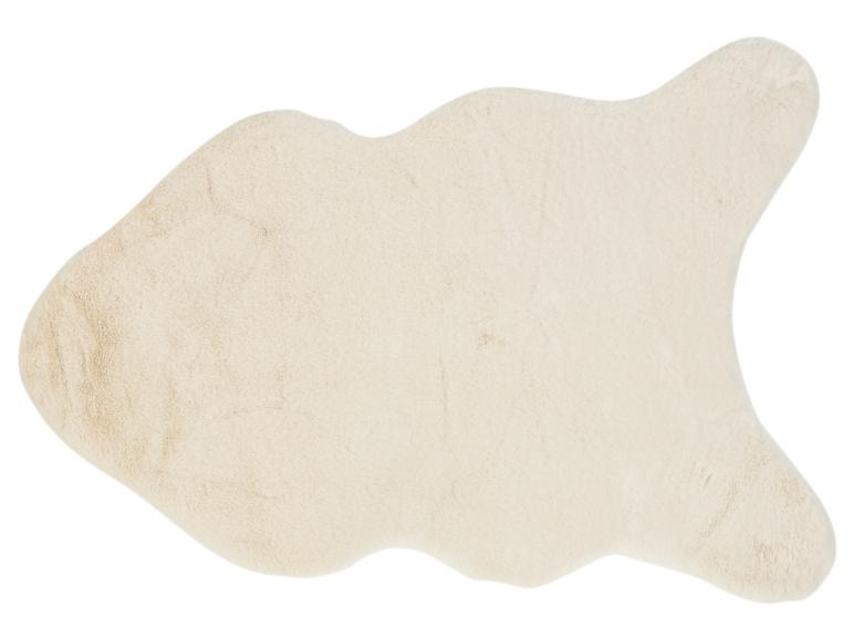 Ein hellfarbener, flauschiger Teppich in Form eines Schaffells.
