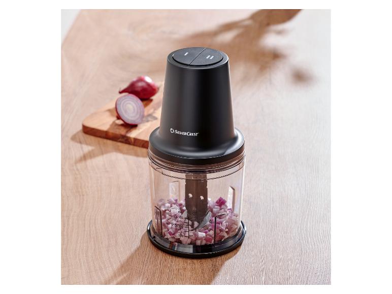 SilverCrest Zerkleinerer mit gehackten roten Zwiebeln auf einem Holzbrett.