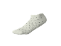 Weißer Socken mit schwarzen Punkten auf schwarzem Hintergrund.