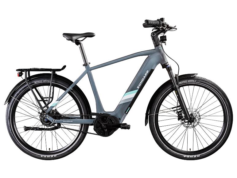 Graues E-Bike mit Gepäckträger und Kenda-Reifen.