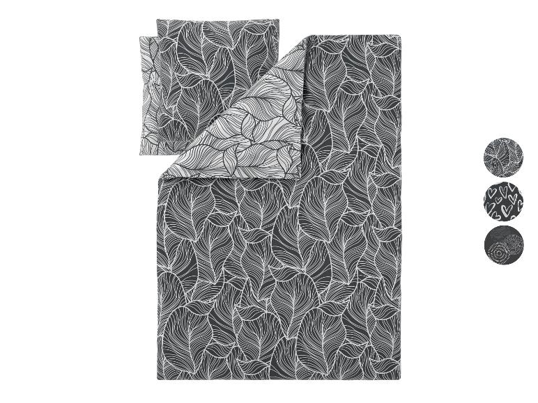 Bettwäsche-Set mit dunkelgrauem Hintergrund und weißem Blattmuster, mit drei runden Mustern, die alternative Muster zeigen.