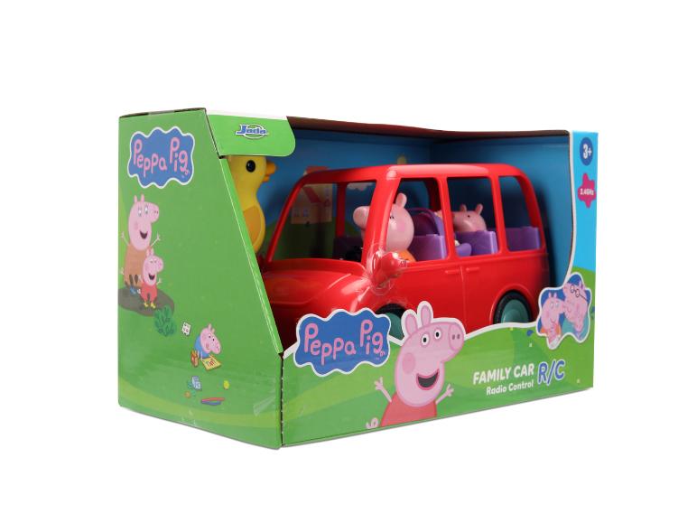 Rotes Spielzeugauto mit Schweinefiguren in einer Box, beschriftet mit „Family Car R/C“.