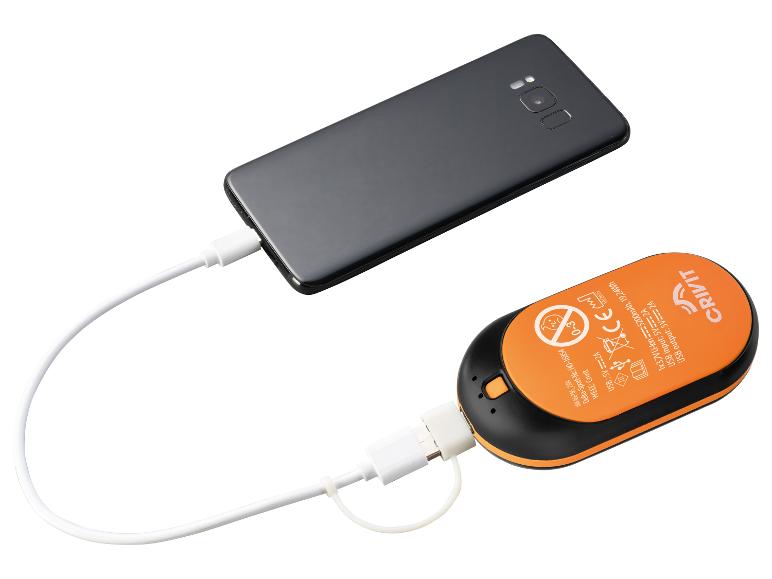 Ein schwarzes Smartphone ist über ein weißes USB-Kabel mit einer orange-schwarzen Powerbank verbunden.
