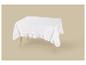 Weißes Tischtuch mit Rüschen auf einem Holztisch vor beigem Hintergrund