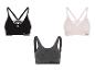 Drei Reebok Sport-BHs in Schwarz, Grau und Rosa.