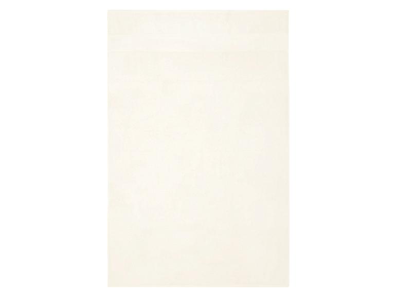 Ein weißes Handtuch mit einem horizontalen Streifendetail.