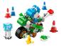 Blauer Dinosaurier auf grünem Motorrad mit Spielzubehör.