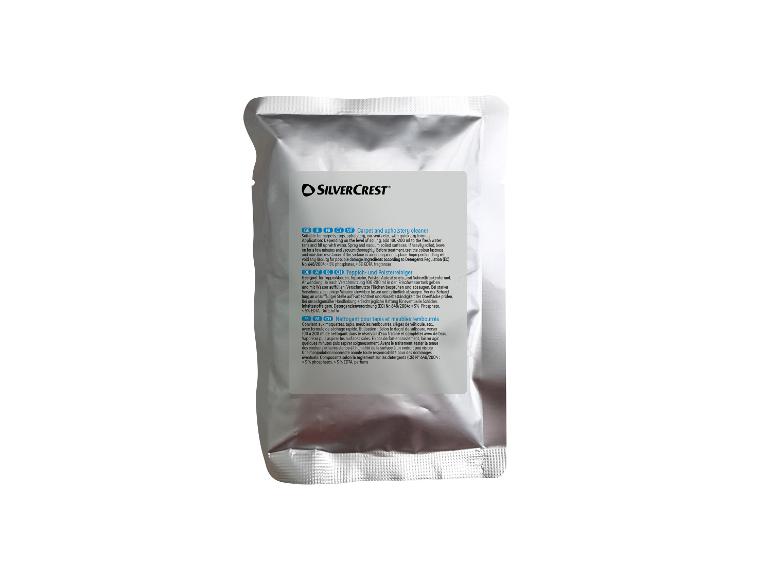 Teppich- und Polsterreiniger in einem silbernen Beutel mit Anweisungen auf Englisch, German und Französisch.