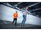 Zwei Läufer in Langarmshirts und Sporthosen, die draußen joggen.