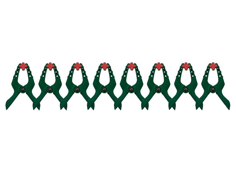 Acht grüne Federklemmen mit roten Spitzen, horizontal in einer Reihe angeordnet.