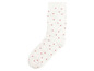 Weiße Socke mit rosa Punkten.