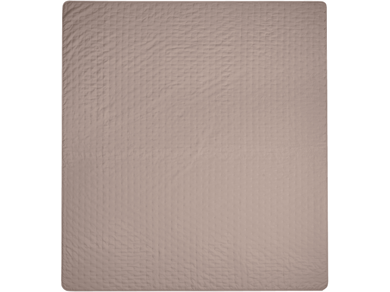 Nahaufnahme einer gesteppten Decke in Hellbraun oder Beige