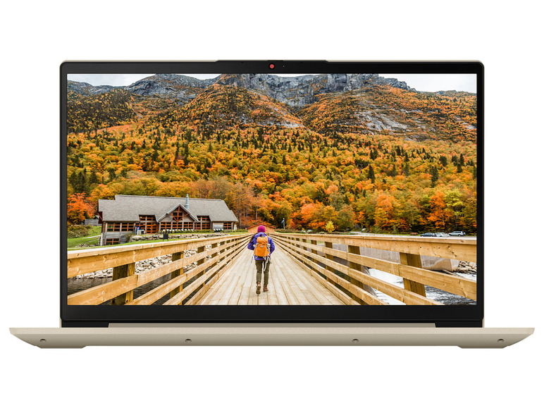 Ein beiger Lenovo Laptop mit einem Bild einer Holzbrücke in einem Herbstwald.