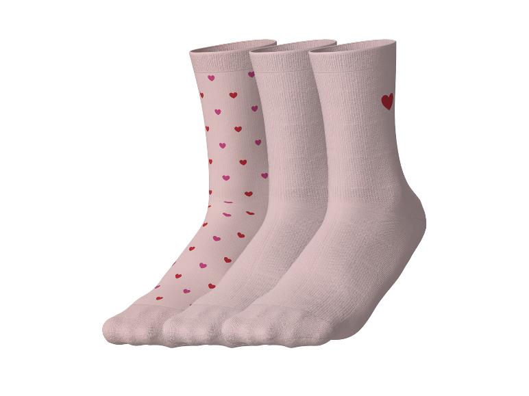 Drei Paar rosa Socken, eines mit roten und rosa Herzen, die anderen beiden mit einem roten Herz.