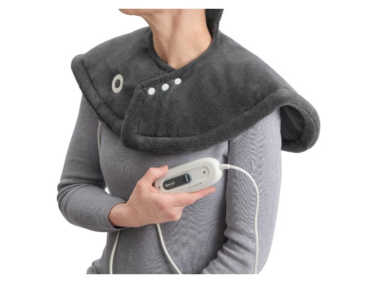 Eine Frau trägt eine weiche, beheizbare Schulter- und Nackenauflage von Sensiplast.