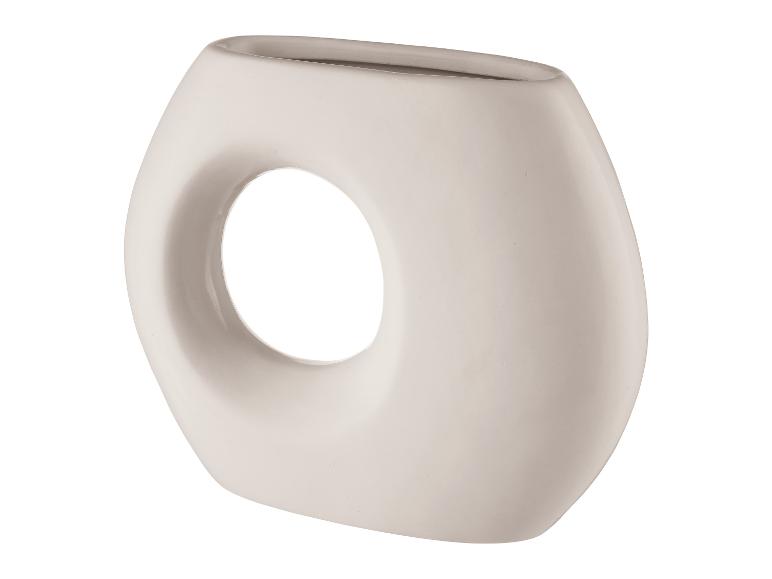 Eine weiße Keramikvase mit einem runden Loch.