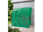 Grünes Tunnelgewächshaus auf einer Holzterrasse, mit Pflanzen innen und im Hintergrund.