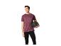 Mann in Sportshirt und Leggings hält einen Medizinball.
