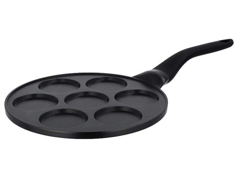 Schwarze Pfannkuchenpfanne mit sieben runden Vertiefungen und Griff.