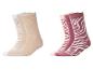Zwei Sets Socken: beige und weiß, sowie rosa und bordeaux mit Zebramuster.
