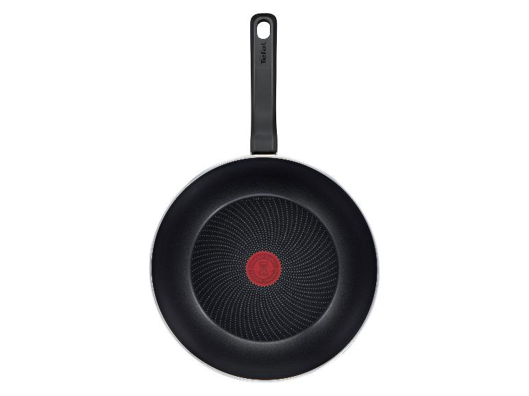 Schwarze Bratpfanne mit Griff und rotem Temperaturindikator in der Mitte.