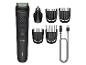 Philips All-in-One Trimmer mit verschiedenen Aufsätzen und Ladekabel.
