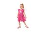 Lächelndes Mädchen in einem pinken Kleid mit Schweinchen-Print und pinken Sneakern