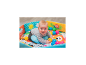 Baby spielt in einem bunten Bällebad mit einem weichen Kissen.